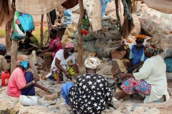 Women sat sorting waste