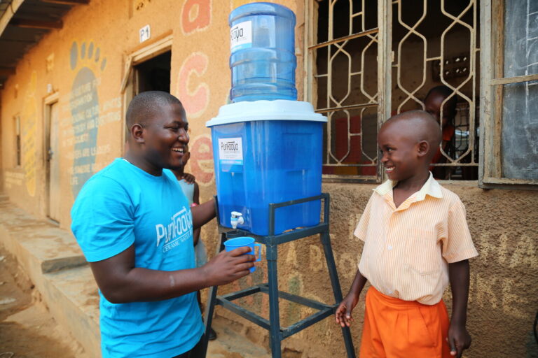 Spouts of Water Ceramic Water filter with man using to pour a glass of water and a smiling child next to the water filter