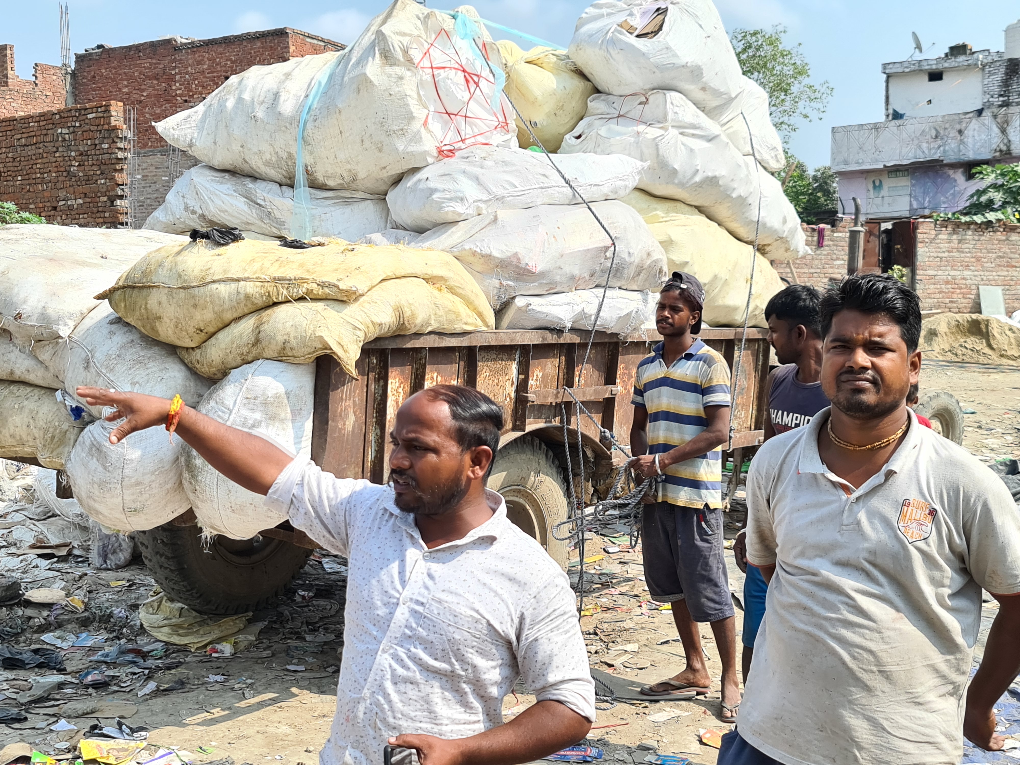 Four men with waste cart piled high as part of Kabidwala business
