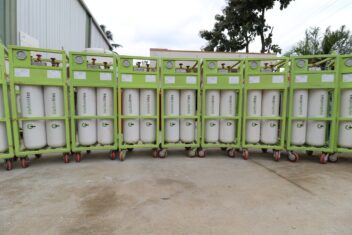 Large CarbonLites Gas Canisters lined up in a row in green and white
