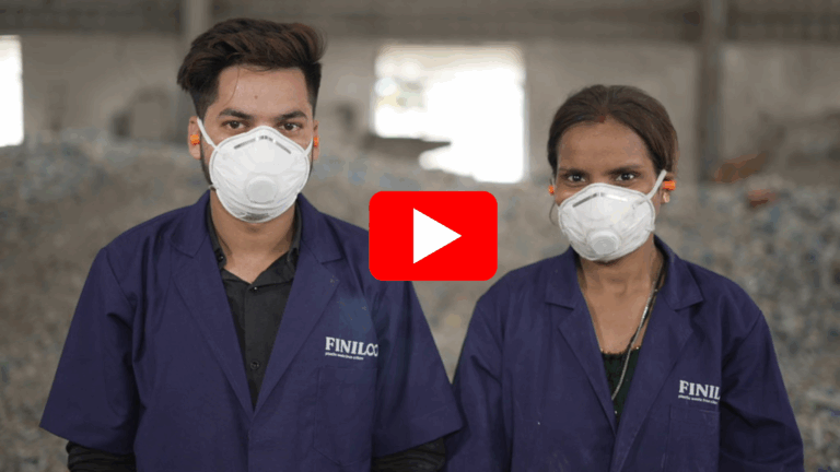 A man and woman stood next to each other with white PPE masks on, ear plugs and blue FINILOOP uniforms