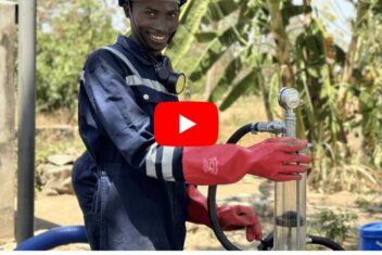 Man smiling holding Pu Pu Pump in PPE